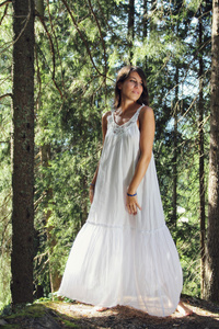 在森林里穿的美丽的年轻女子白