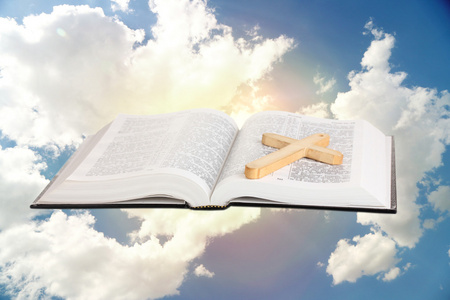 木制的十字架的天空神圣的圣经和天空背景上的木制十字架照片