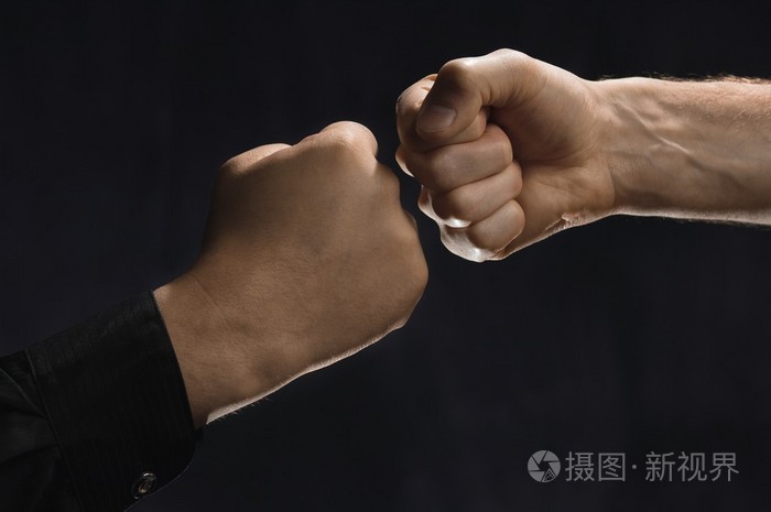 两名男子的拳头碰在一起