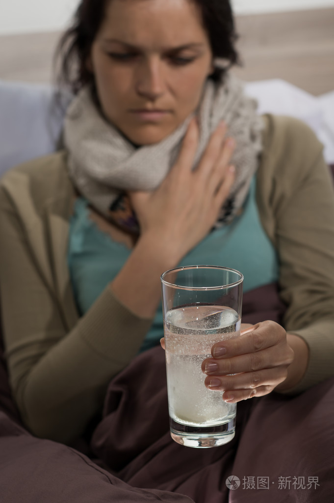 生病的女人准备喝感冒药