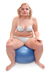 练习球超重的女人的照片。卫生保健的概念