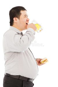 胖商人喝啤酒杯吃汉堡包