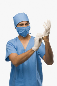 手术铅衣外科医生穿上手术手套照片