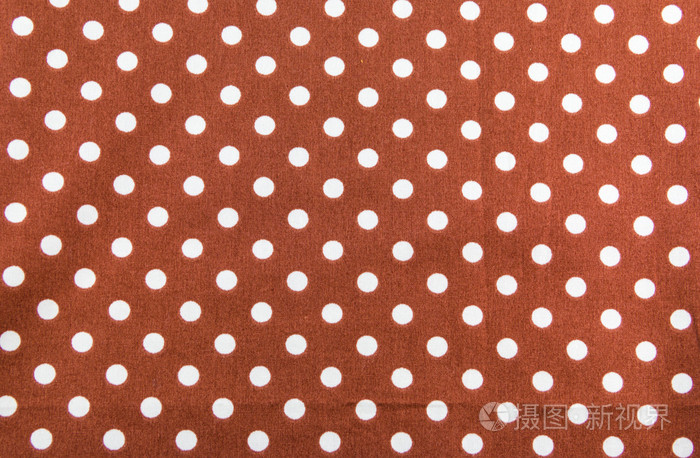 棕色背景上的白色的小圆点