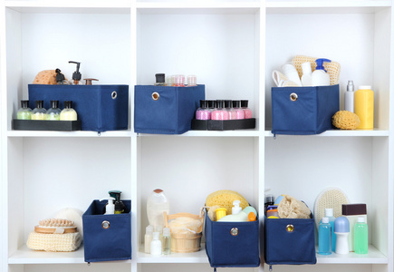 蓝色纺织框与美容产品为白色的书架上的个人护理