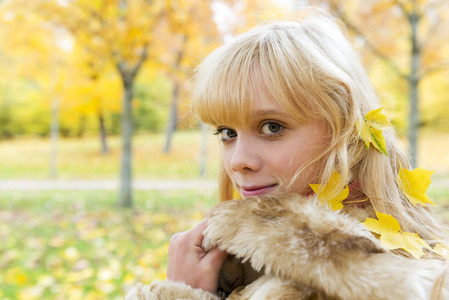 美丽的金发女孩，在秋天的公园