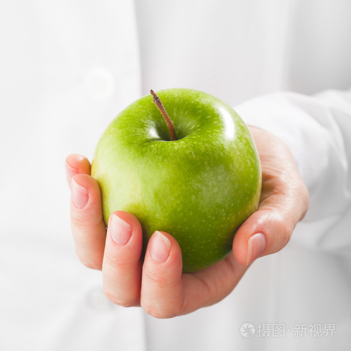 绿色的苹果，在手里，白色背景
