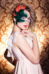 美丽的年轻女子戴着绿色神秘的威尼斯面具新年狂欢节，圣诞化装舞会，秘密夜总会