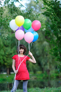 快乐的年轻孕妇用手中的气球