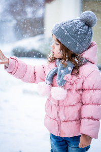 可爱的小宝贝女孩粉红色的外套和灰色的帽子，享受第一个雪 b