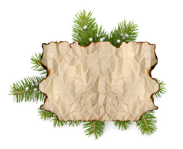 旧羊皮纸纸与副本空间隔离的圣诞节树分支背景上