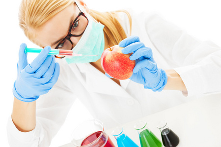 科学家注射化学物质在桌上的苹果
