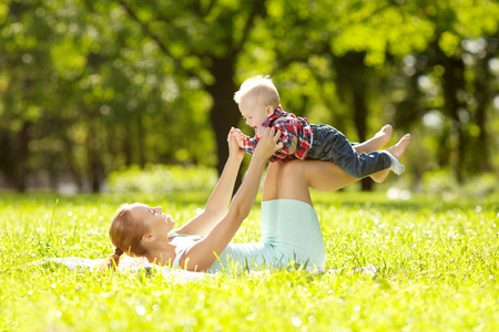 可爱的小宝宝和妈妈在草地上在公园。甜 bab