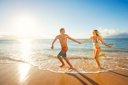 幸福的夫妇，在日落时分的热带海滩上