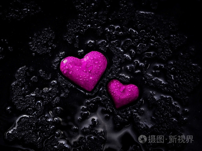 在湿的黑色地面上的心