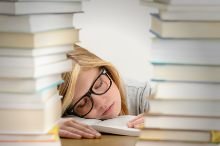 学生女孩睡在堆书