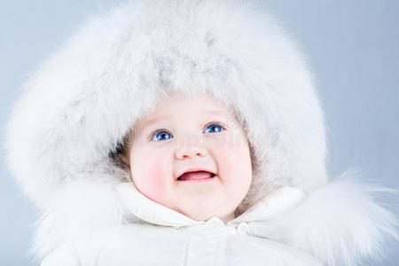 快乐的笑宝宝穿着白色的冬衣