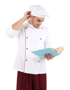 专业的厨师，与白色的制服，戴雨帽，孤立的白色衬底上的书
