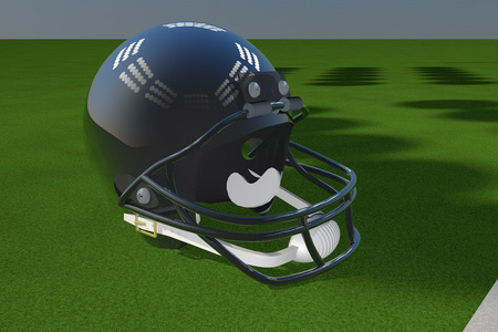 橄榄球头盔在绿色的田野