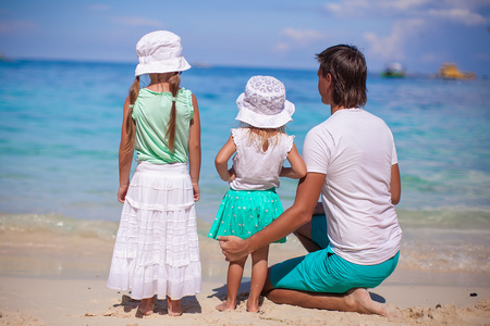 可爱的小女孩和年轻爸爸，热带的白色沙滩上