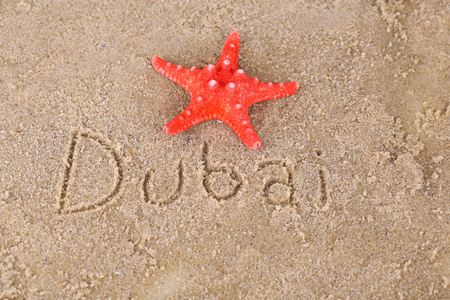 Inschrift Dubai im nassen Sand closeupHintergrund湿砂特写背景题字迪拜