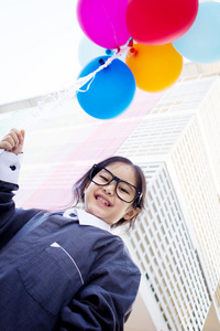 可爱的小亚洲业务孩子拿着气球