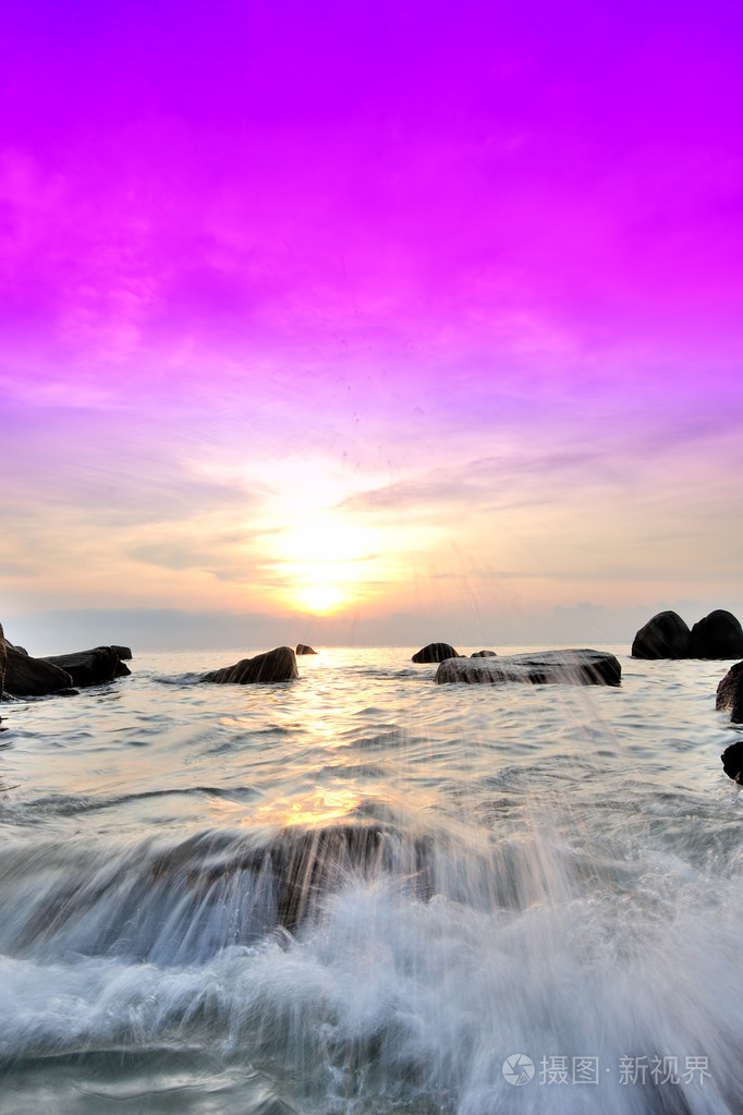 日出观大海与海浪的岩石