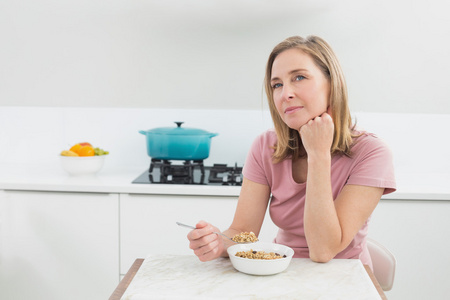 心思的女人，在厨房里吃谷类食品