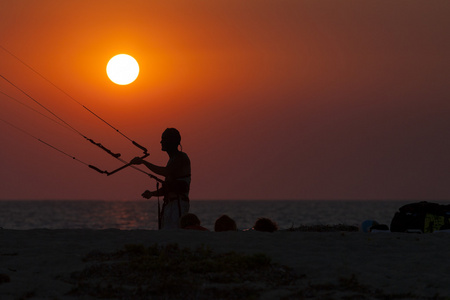 航行在日落时的 kitesurfer 的剪影