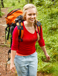 在森林里徒步旅行的年轻女子。