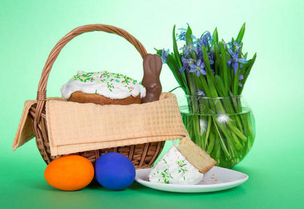 篮子里的复活节蛋糕和五颜六色的鸡蛋