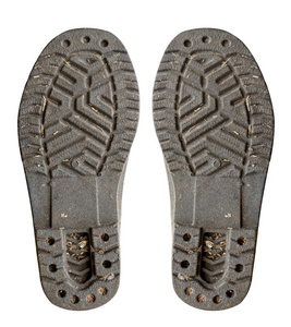 孤立的白色背景上的脏的旧的靴子鞋底照片