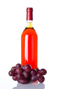 Bottle of ros wine and red grapes