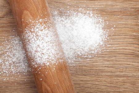 擀面杖用木制的桌子上的面粉