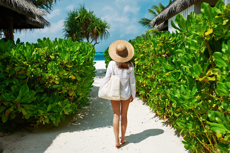 去海滩的袋和太阳帽子的女人
