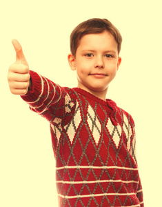 性格开朗金发小男孩在一件红毛衣，举起手指分离