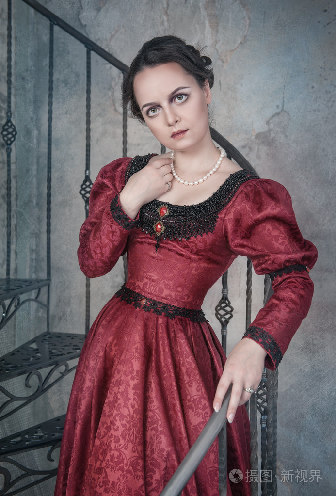 美丽的女人,穿着中世纪在楼梯上