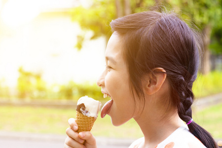 动漫吃冰棒快乐的小女孩,用日落背景吃冰棒照片