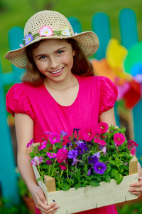 园艺 种植可爱的女孩在花朵的花园里工作