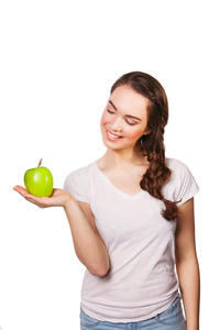 美丽的年轻女子，与绿色的苹果。健康的饮食概念