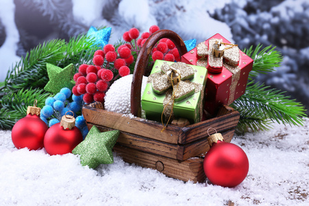 圣诞装饰品在篮子里，在明亮的背景上的枞树组成