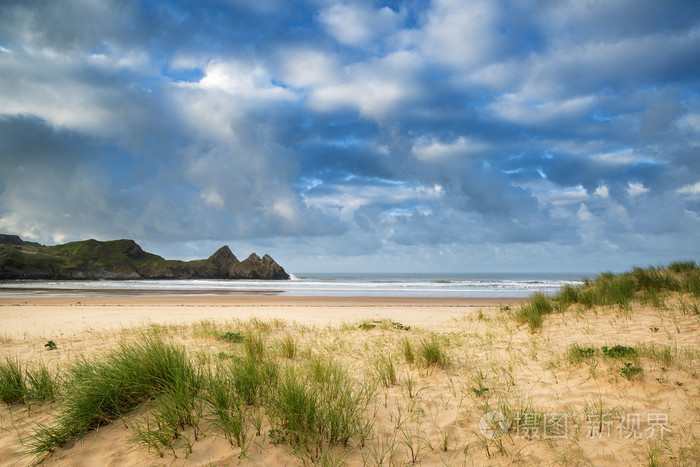 美丽的蓝色天空今天上午在三面石壁的沙质海湾的景观