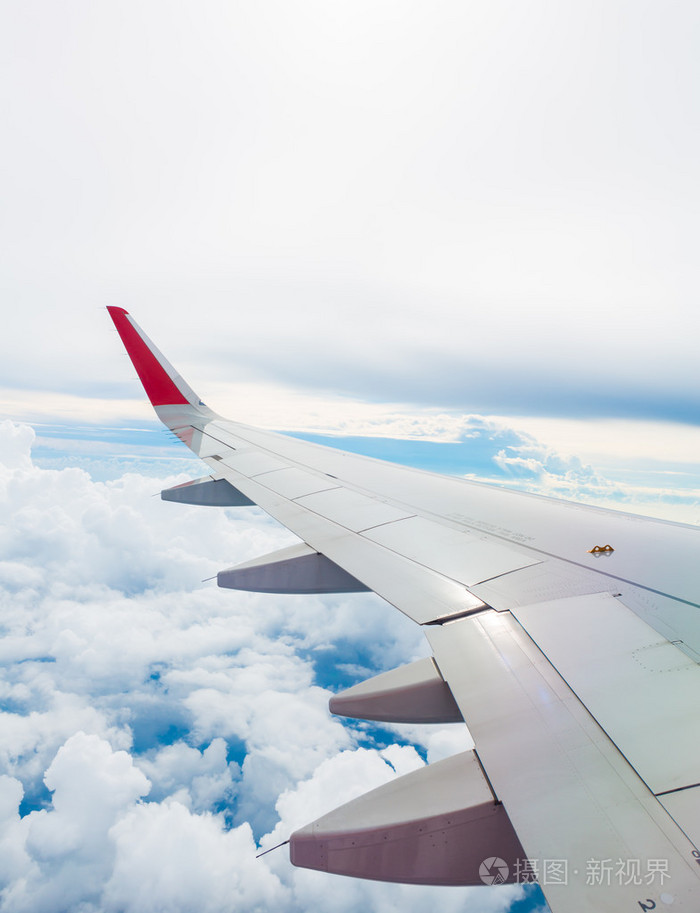 一架飞机在云层上面飞翔的翅膀