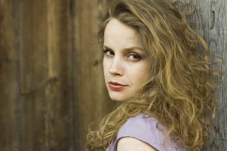 beautiful 卷曲的金发女郎享受农村阳光.在头发中的曙光.乡村风格.