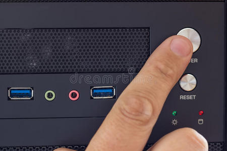 电源配件在桌面电脑上用手指按电源键照片
