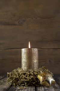 一个燃烧的金色到来蜡烛，木制仿古背景