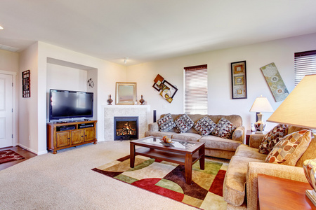 白色客厅的壁炉和五颜六色的地毯