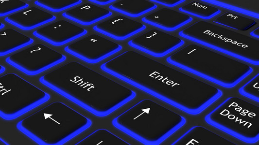 蓝色的光背景黑色的笔记本电脑键盘