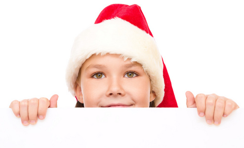 小女孩在圣诞老人的帽子持有空白板