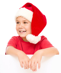 小女孩在圣诞老人的帽子持有空白板